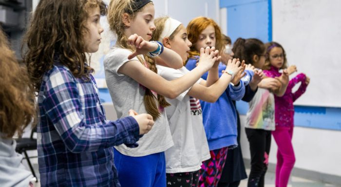 girls holding hands in a line
