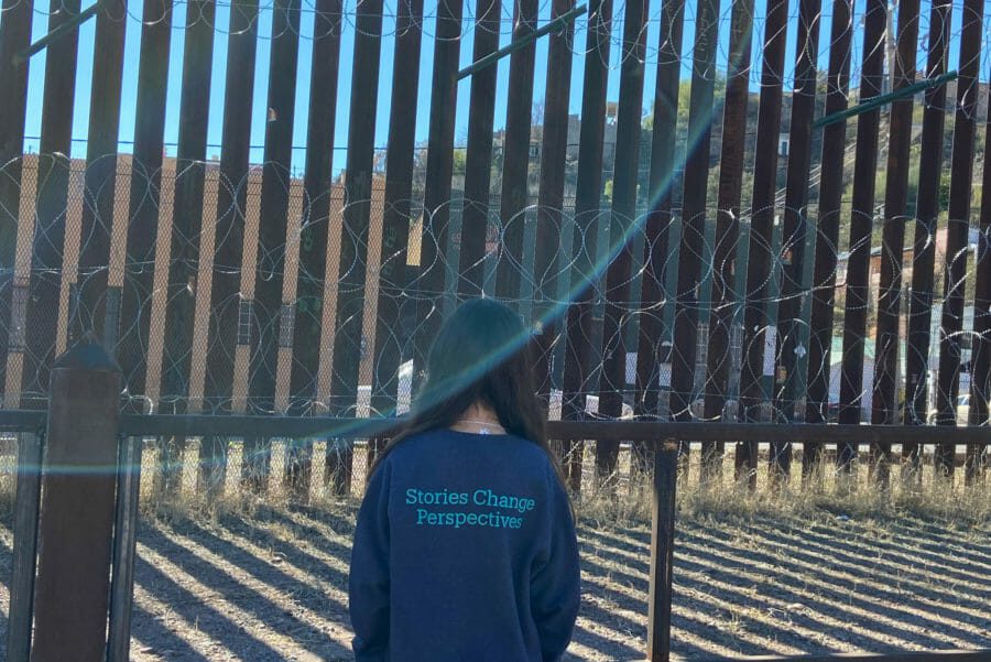 back of sweatshirt that reads Stories Change Perspective