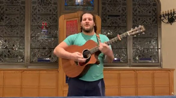 Michael Harlow playing guitar for pre-shabbat family jam